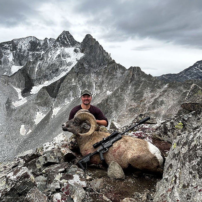 hunter with a bighorn sheep